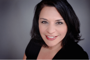 A headshot of Michelle Lopez-Rios in front of a plain backdrop.